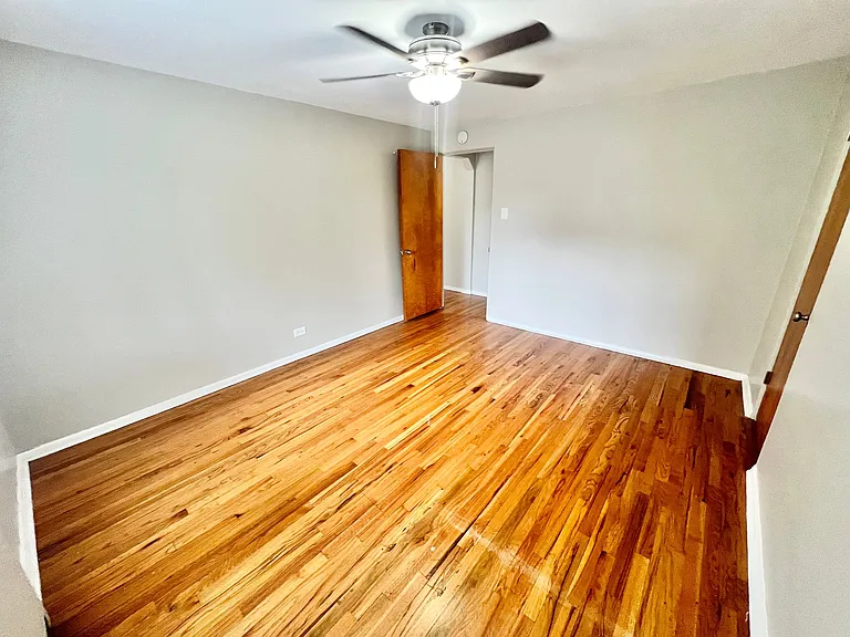 Step into comfort with this inviting room featuring elegant hardwood flooring. Step into comfort with this inviting room featuring elegant hardwood flooring.