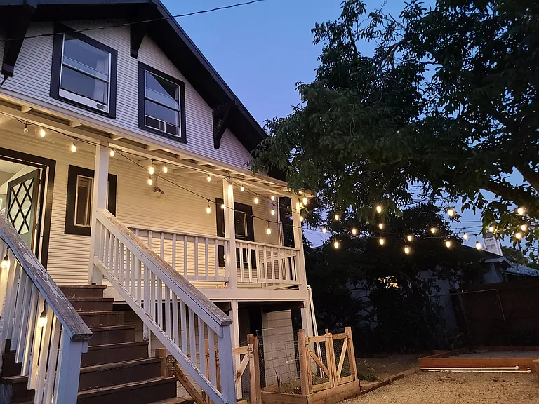 Relaxing sizeable backyard with many fruit trees and two raised and enclosed vegetable garden beds for your use.