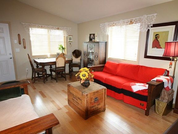 Looking from hallway to living room and front entry.
