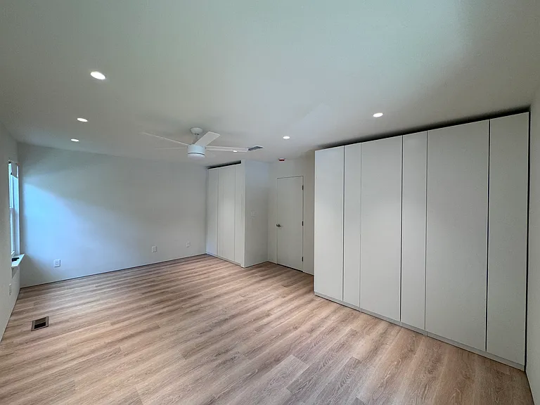 Bedroom 2 - Second spacious primary-style bedroom with generous closet storage and new flooring.