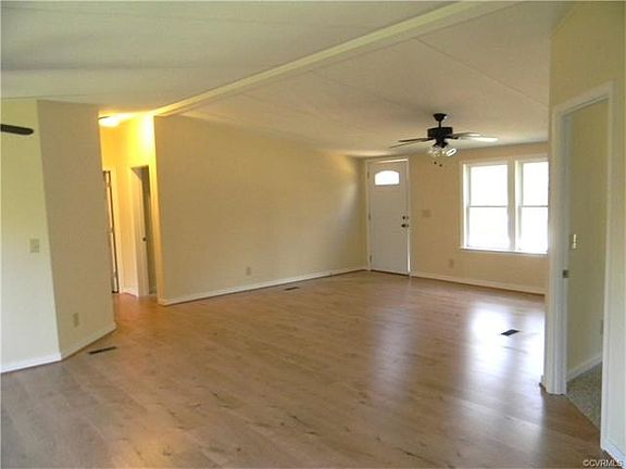 Great Room wit  NEW Floorin, looking to front door, with Master on right