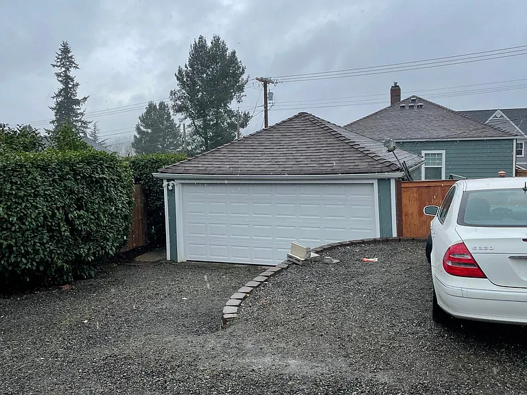 Back entrance with garage and parking