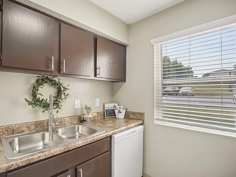 One bedroom kitchen with large window and dishwasher.