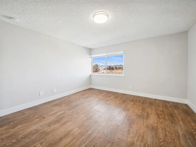 Large spacious bedrooms with wood flooring