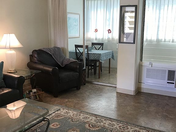 Leather Club Chair and Dining area on enclosed lanai