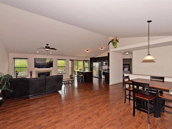 Open floor plan with vaulted ceilings and decorative niches.