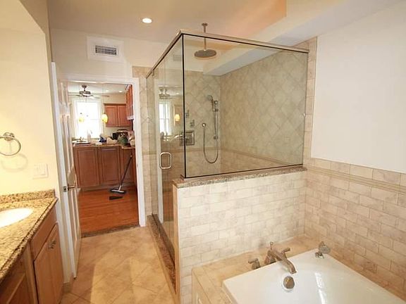 Jaccuzi tub, custom free standing shower with hydrastatic dual heads, his/hers sinks, heated impotd rialto tile floors