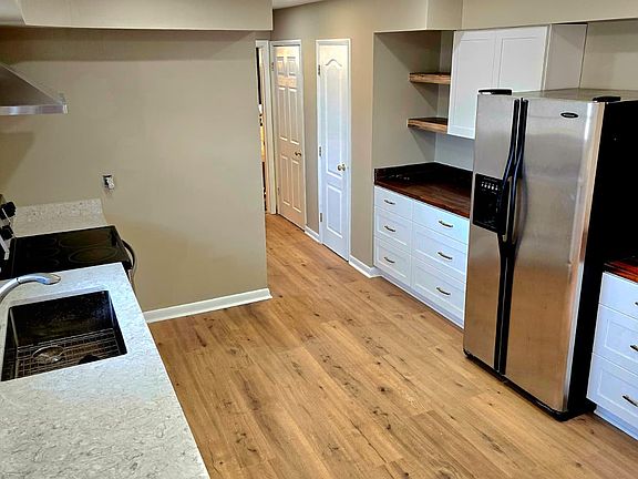 Gorgeous kitchen boasts granite and butcher block counter tops, extra large sink, stainless steel appliances and ample storage.