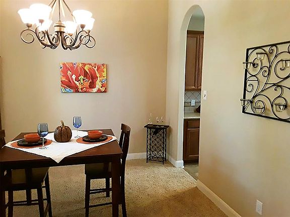 Large formal dining room with upgraded lighting fixture.
