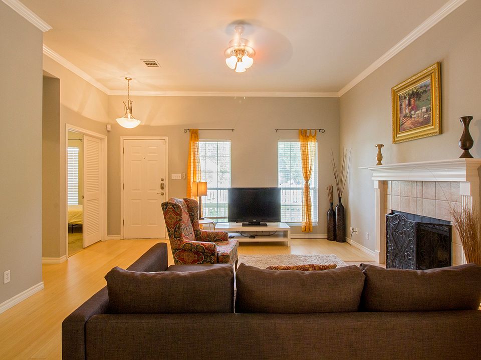 Living area, working fireplace. Door on left to 2nd bedroom. Hall on left to 3rd bedroom and hall bath.