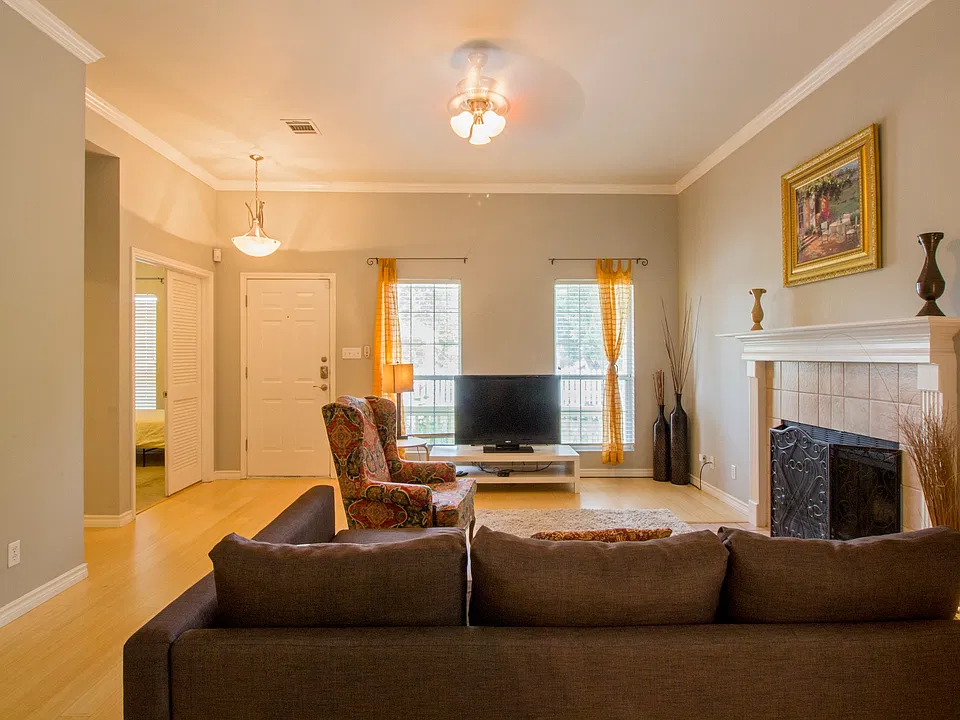 Living area, working fireplace. Door on left to 2nd bedroom. Hall on left to 3rd bedroom and hall bath.