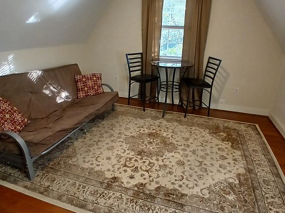 Living room area with dining room table & area rug