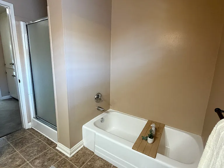 Full restroom has a bath tub and stand up shower