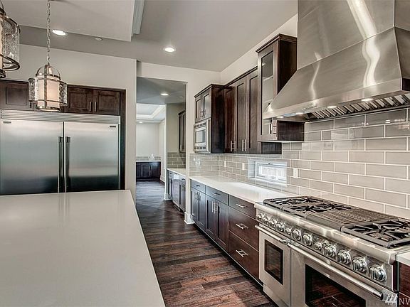 Photos are of a similar plan; details will vary due to builder and buyer options. All of Foxwoods' homes will include 48" Thermador Pro-Series Range and Hoods, 60" side by side refrigerator & freezer, stacked cabinets w/crown extending up to the 10' main floor ceilings, 5 stain-options for cabinets as well as painted upgrade options.