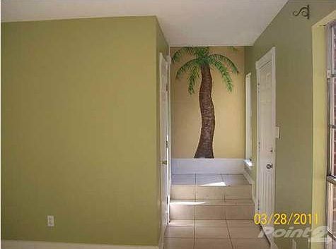 VIEW OF PALM TREE MURIAL ON STAIRWELL FROM LIVING ROOM