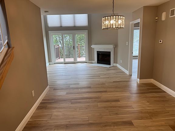 Main floor entry. All new flooring with a wood burning fireplace and door that leads to a composite deck. Freshly painted.