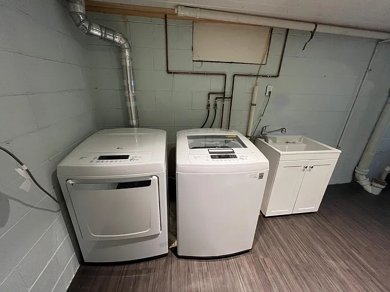 Washer, dryer, utility sink in basement.