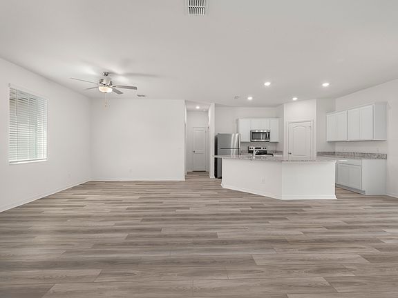 The family room is spacious and has a sliding glass door leading to the backyard