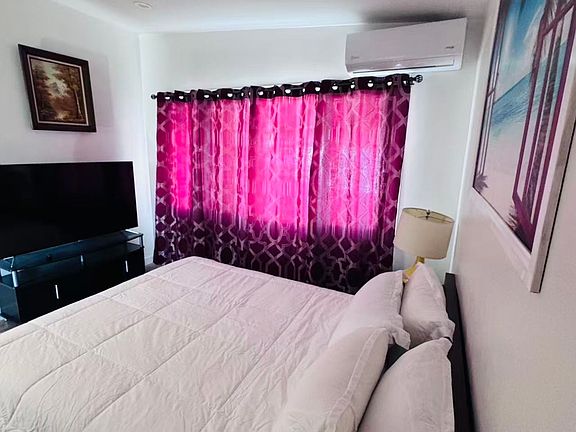 Spacious bedroom with TV and comfortable bed