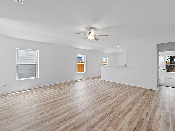 Three windows bring in plenty of natural light into the family room and kitchen.