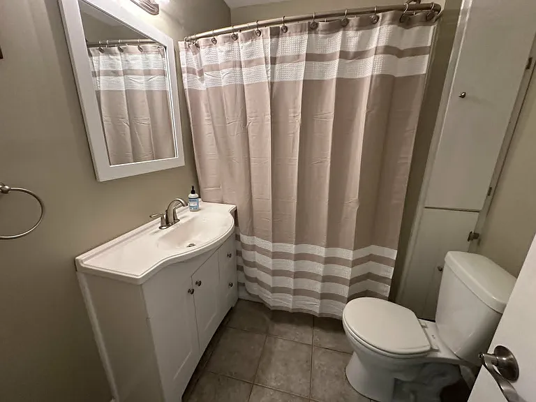 Clean, updated full bathroom with modern vanity and shower/tub combination.