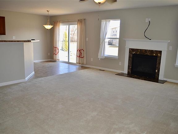 Entertain with this open floor plan and bright living room. Gas fireplace adds a touch of cozy to the cooler days and the screened slider opens up to the back yard for breezy spring days!
