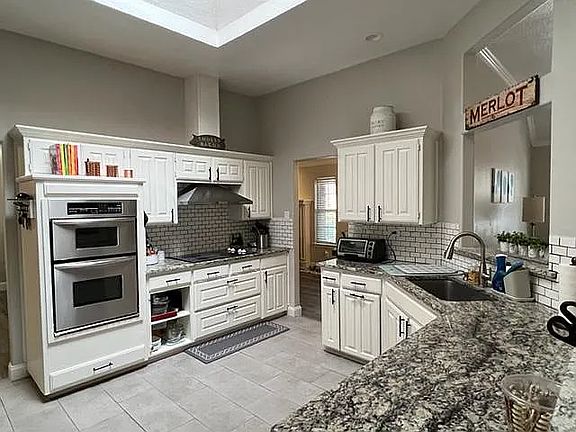 The BEST natural light in the centrally located kitchen, courtesy of a large skylight. 
Connected to the dining nook, great room, and bonus den/dining area. 
You can see the pass through window to the bonus den as well as the dining nook.