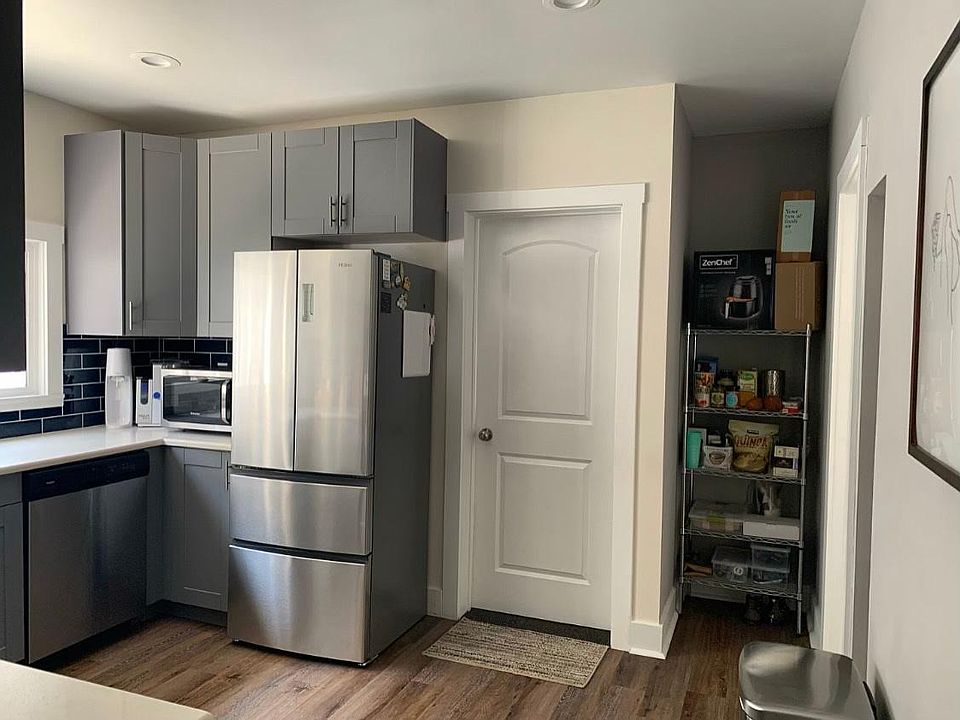 Kitchen storage/pantry area. Back door leads to back stairwell which goes to backyard and basement with laundry.