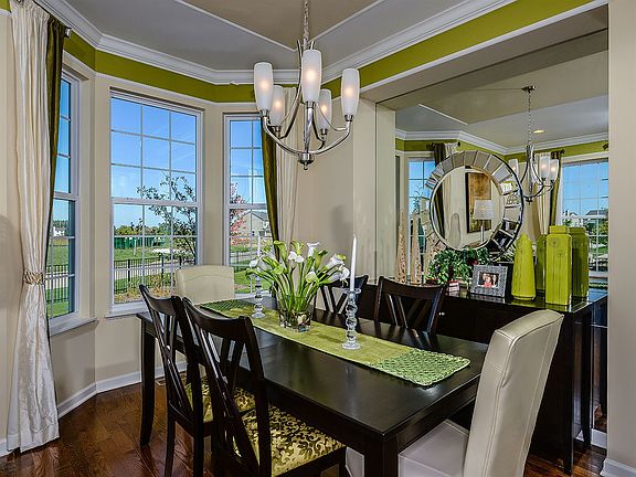 The dining room overlooks the family room with a beautiful window opening. This layout hosts an idea
