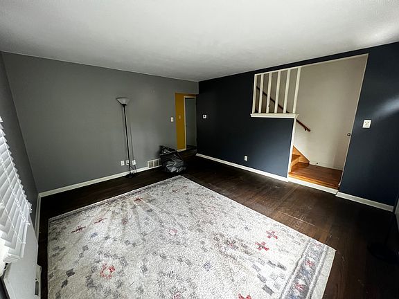 Bright living room with a large picture window overlooking the front yard