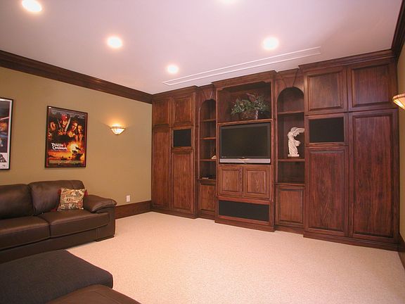 Theater Room w/ Projection Screen and Custom Entertainment Center