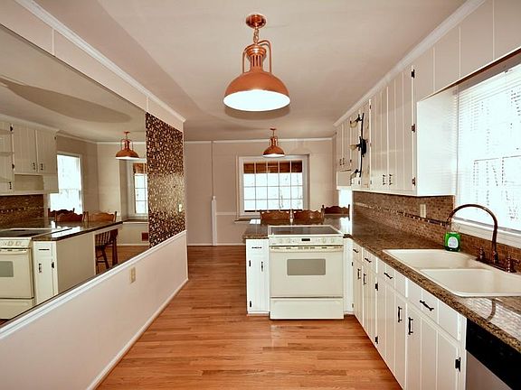 Galley kitchen with pool view from double sink and breakfast area!