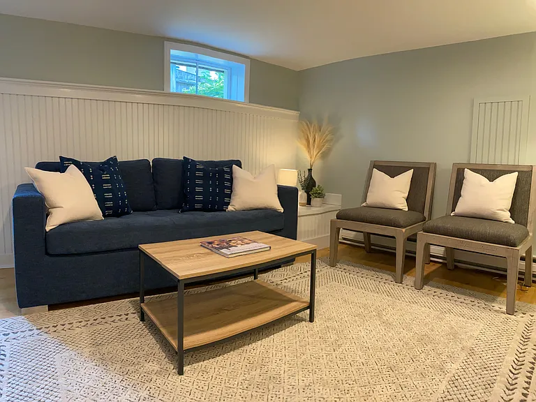 Finished basement with sleeper sofa, 40 inch TV and work desk