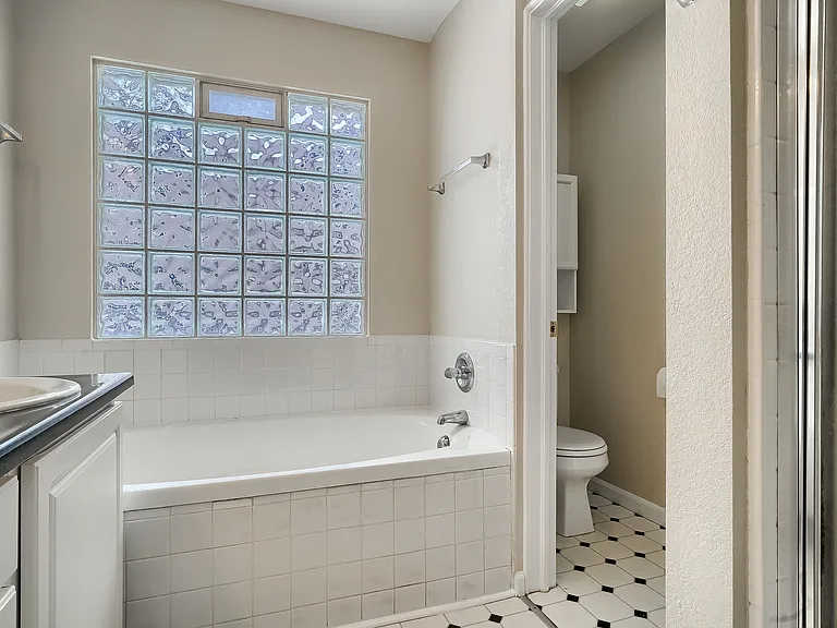 Primary bath with double vanity, soaking tub, shower, toilet
