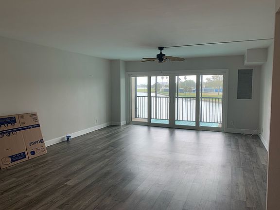 Living Room New Hardwood Floors & Hurricane Proof Sliding Doors