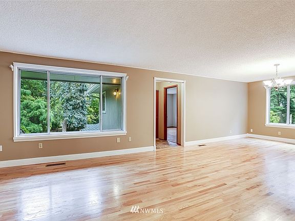 Standing in front of the stairs, you can see the doorway into the main floor master bedroom and en-suite.