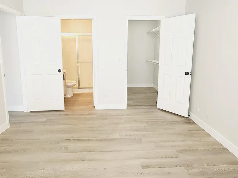 master bedroom with walk in closet and ensuite bathroom