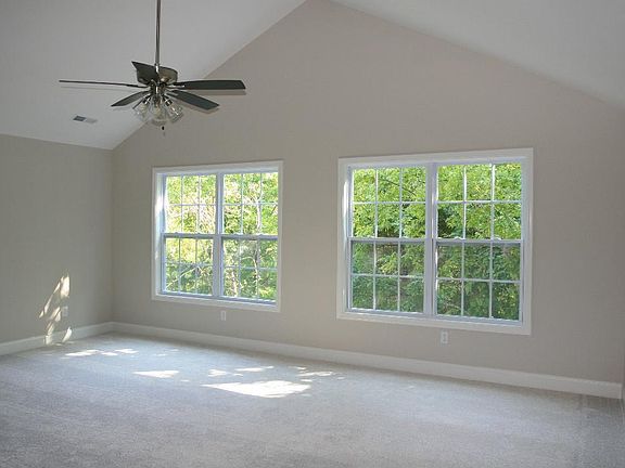Master bedroom view of woods and greenway. Spring time