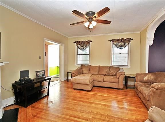 Refinished and polished hardwood floors gleam in the natural sunlight.
