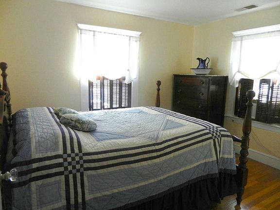 Northwest bedroom with poster bed with blue and white antiqu