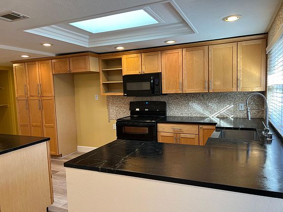 Open kitchen with skylight. A lot of natural light in the kitchen area.