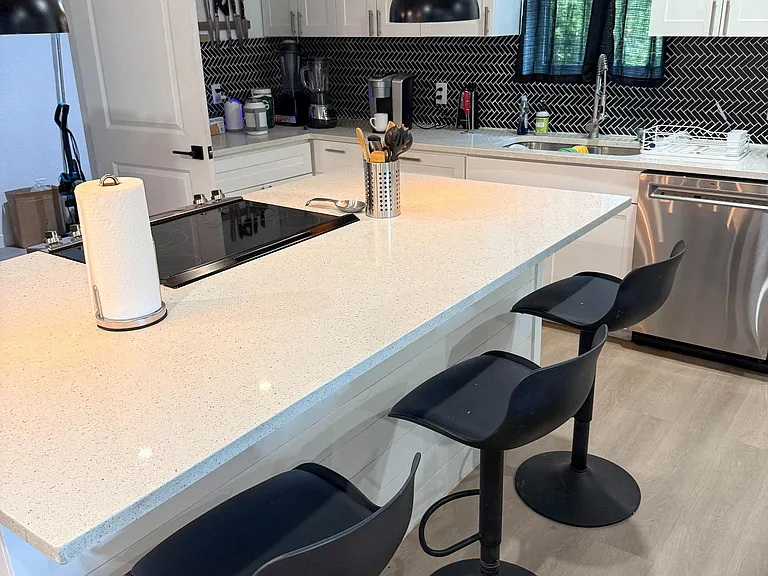 Electric cook top with three bar stools for seating