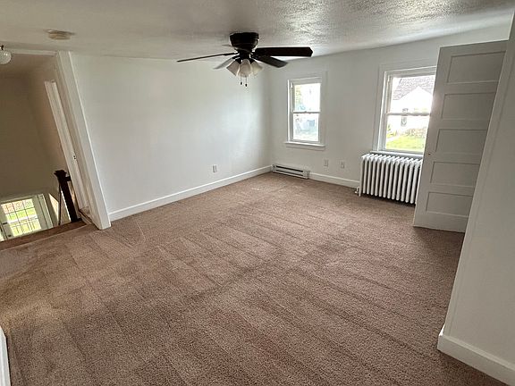 Roomy living room area include an abundance of natural light, ceiling fan, and spacious closet.