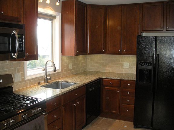 Kitchen - Granite Tops, Under counter lights, travertine tile floor