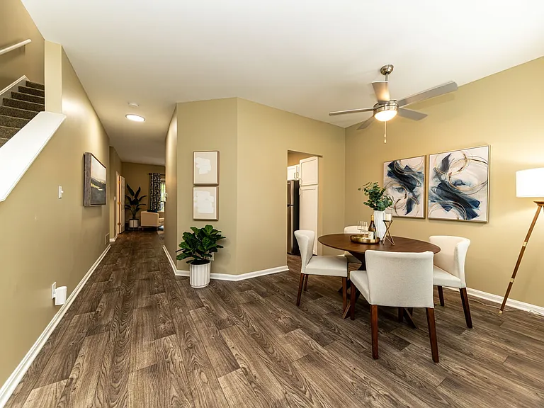 Dining area with hardwood-style flooring and overhead lighting