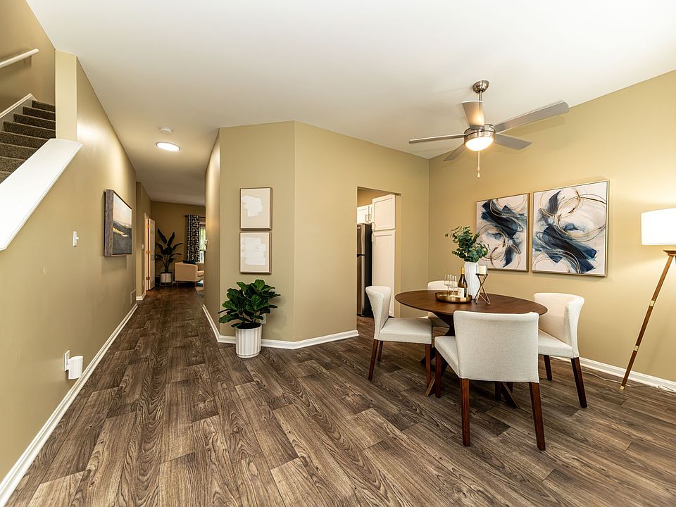 Dining area with hardwood-style flooring and overhead lighting