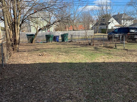 Back yard facing alley. Hard is fenced in.