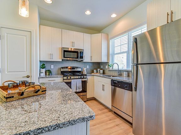 Gorgeous granite counter tops, herringbone glass back splash & Stainless Steel Appliance Package with Gas Range