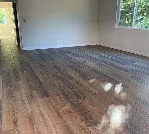 picturesque pool view from the living area and is filled with natural light. The home features stylish new wood grain flooring in the main living spaces, plus new windows.