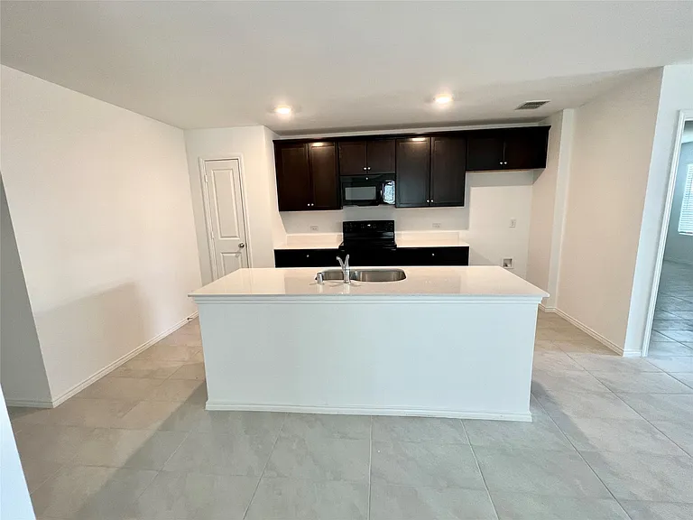 kitchen has quartz counters, beautiful cabinets and pantry